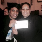 Constance Malcolm (mother of Ramarley Graham) holding her FU4J Xmas Fundraiser check, posing with Cynthia Howell.