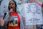 Lisha Garner Flagg, sister of Eric Garner, speaks out at the National Day of Protest to Stop Police Brutality, with the portrait of Eric next to her. Portrait by Rrtist Rose Jaffe. October 22, 2014.